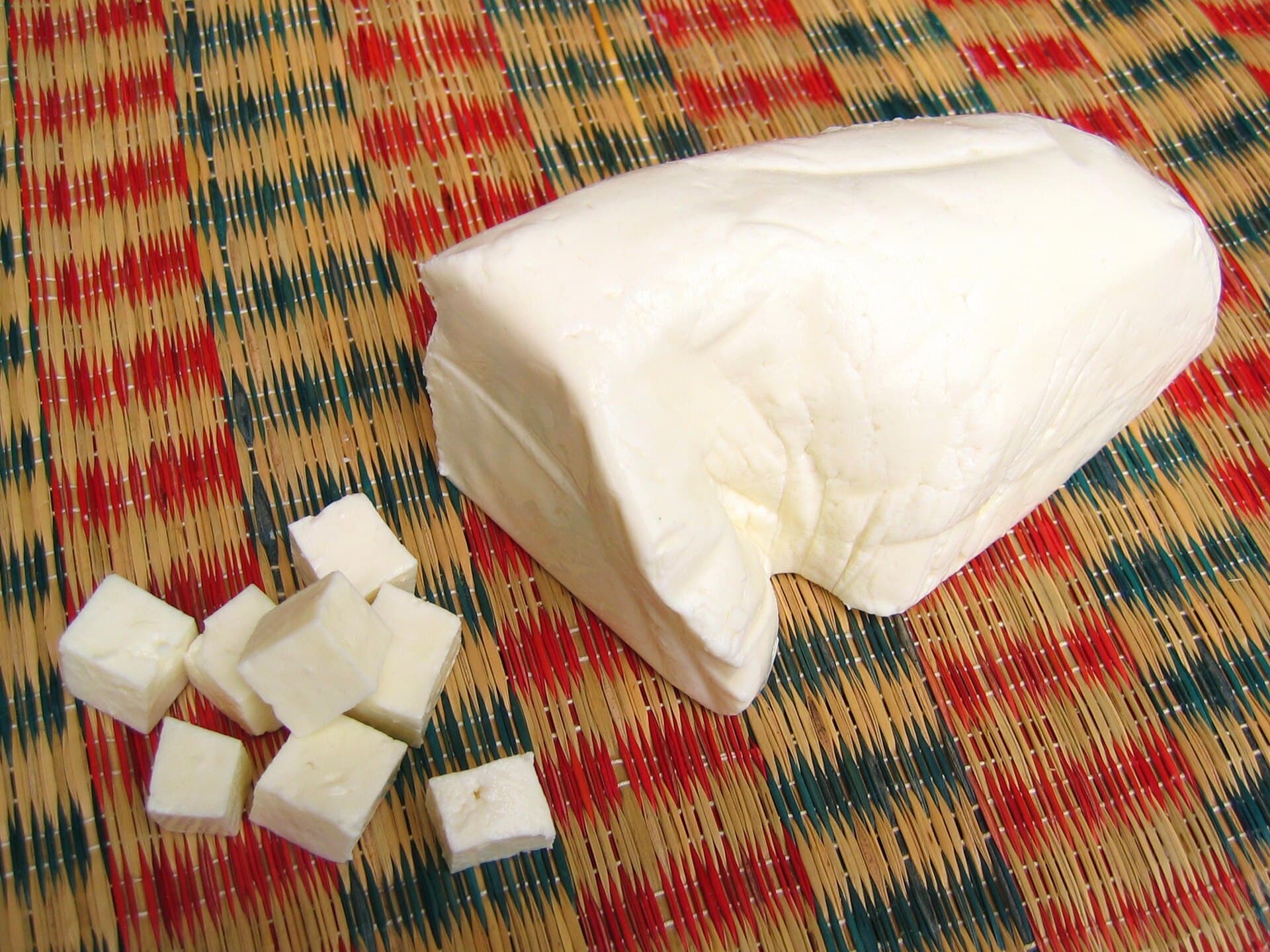 A block of fresh paneer with cut cubes
